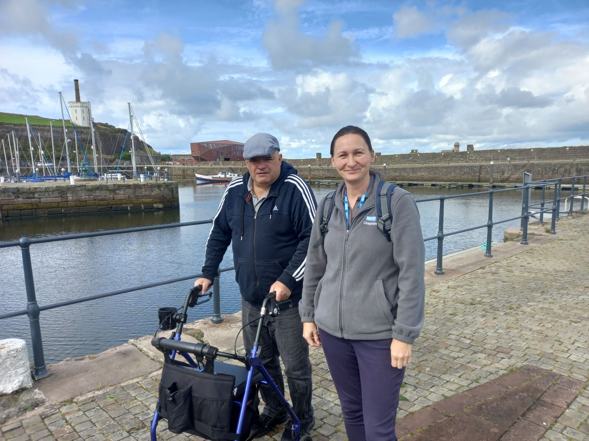 2 people walking around harbour